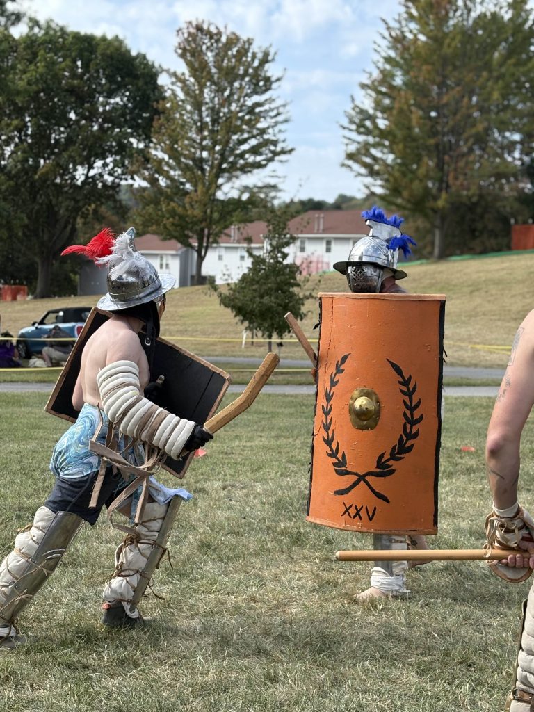 two people, one weapons and other shield